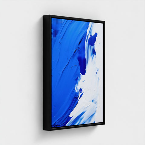Abstract art print with blue and white colors in a black frame on a light gray background