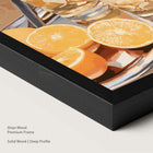 Artwork of oranges and drinks glasses on a tray in a onyx wood frame.