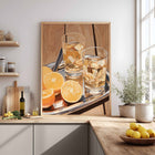 Modern kitchen with a decorative wall art print of glasses with lemon slices and a tray.