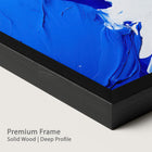 Blue abstract painting with a onyx wood frame on a plain background