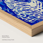Framed artwork of a blue leopard in a natural wood frame.