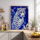 Framed art print of a blue leopard on a kitchen countertop.