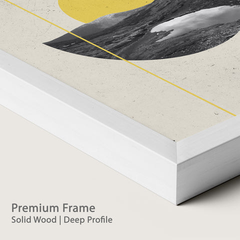 Artwork in chalk wood frame with a mountain landscape and yellow circle.