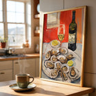 Framed art print of oysters and wine on a kitchen counter with a cup of coffee.