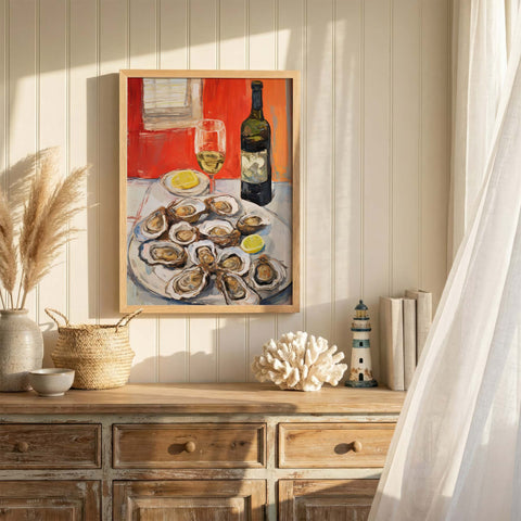 Framed art print of oysters and wine on a dresser with decorative items.