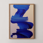 Framed abstract art print with blue brushstrokes on a beige background
