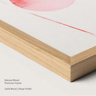 Natural wood framed pink abstract artwork.