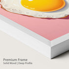 Close-up of a framed artwork with a pink background and chalk wood frame.