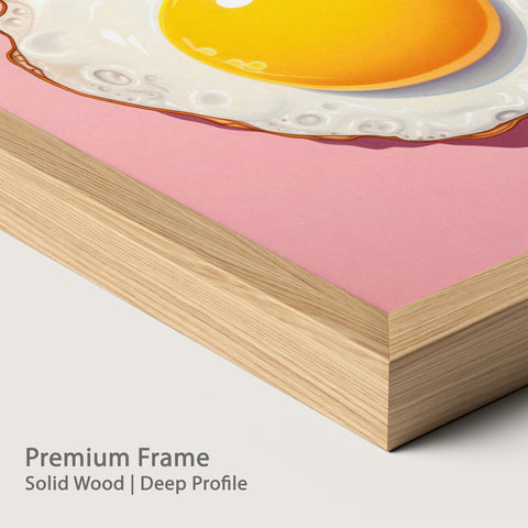 Close-up of a premium natural wood frame with an illustration of a fried egg on a pink background.