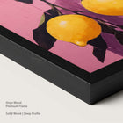 Artwork of lemons on a pink background within a onyx wood frame.