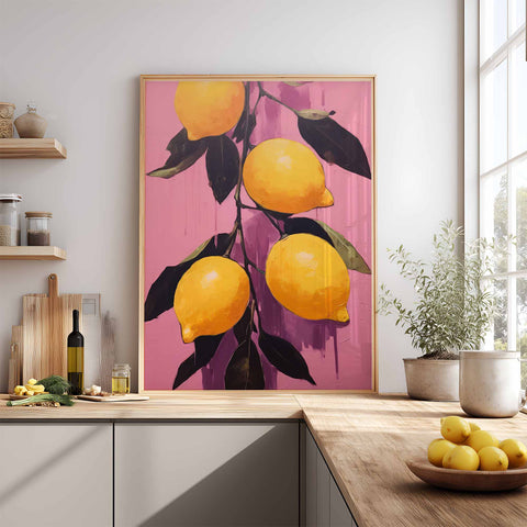 Framed art print of lemons on a pink background in a kitchen setting.